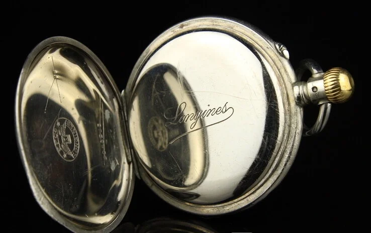 B. Reinin pocket watch — open caseback with Longines movement
